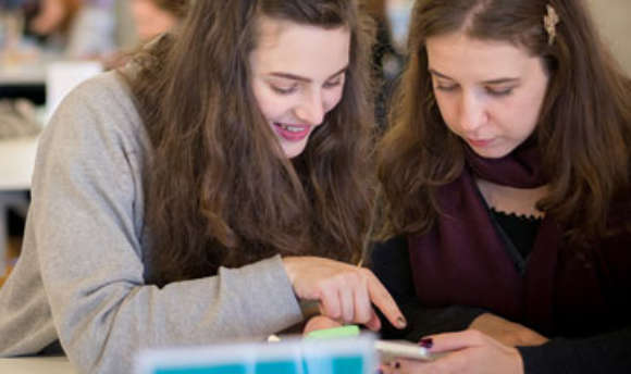 A pair of  students working together using a mobile app
