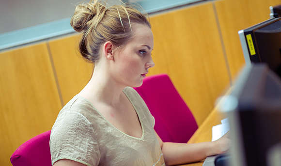 A  student working alone at their computer desk, Edinburgh